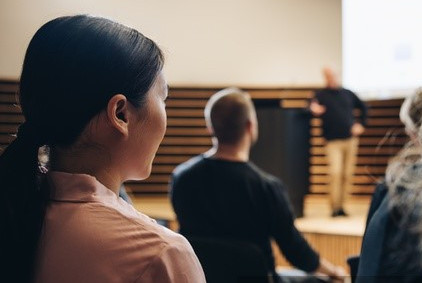 Rear view of a people sitting in audience attending a corporate event by Jacob Lund Photography from Noun Project (CC BY-NC-ND 2.0)